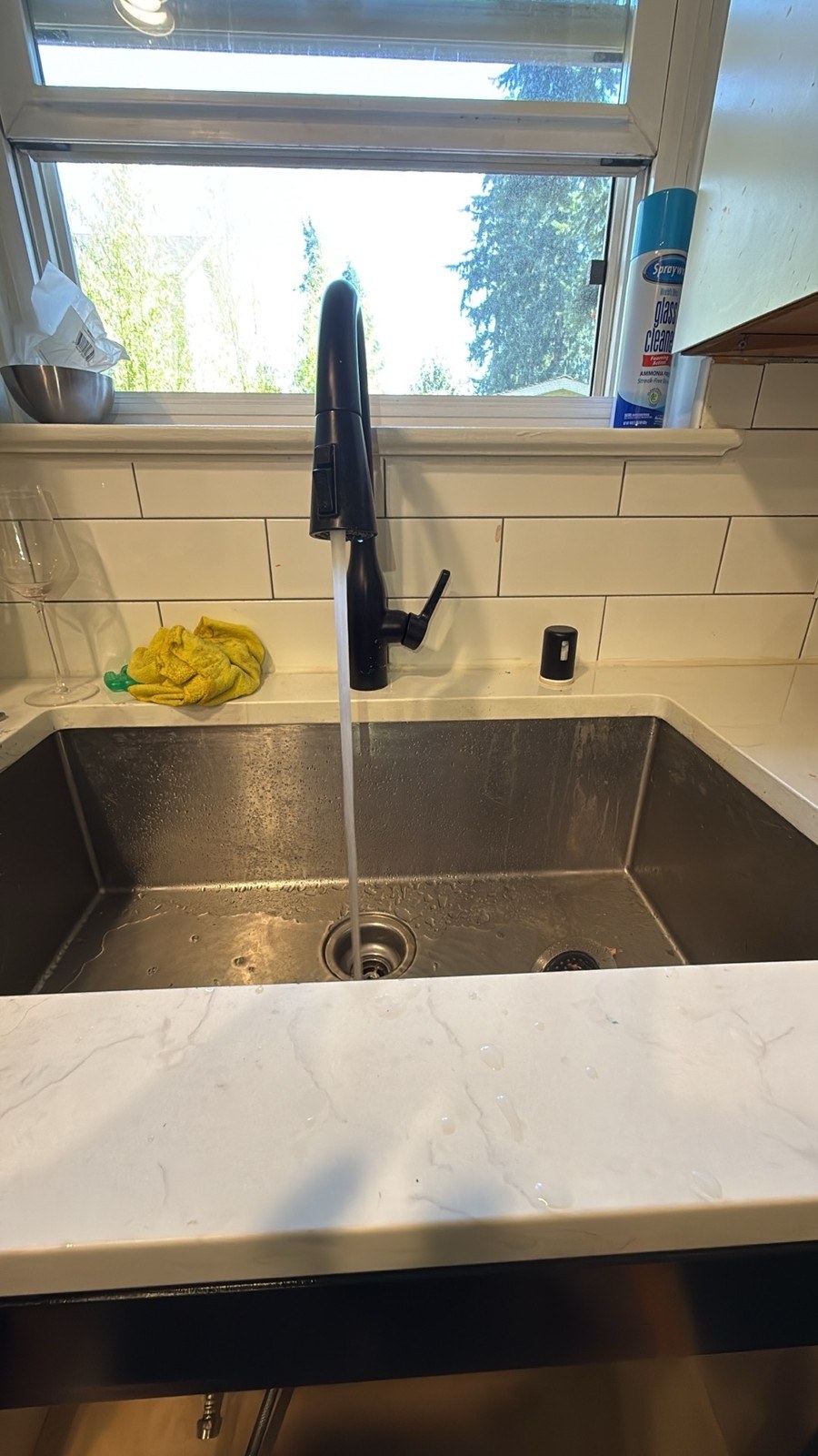 Finished Shoreline kitchen with water running from the faucet into a stainless undermount sink