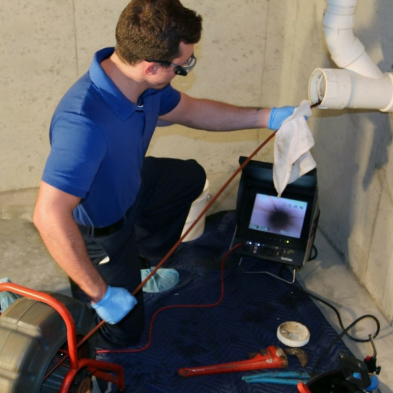 Plumber unblocking a drain